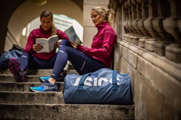 Picture Women reading with travel bags